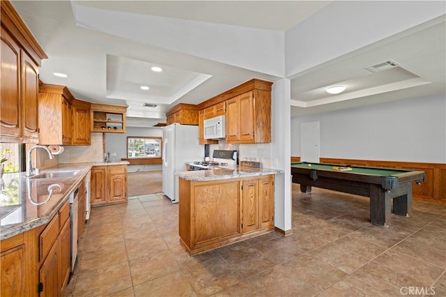 kitchen featuring open shelves, a sink, white appliances, a tray ceiling, and visible vents