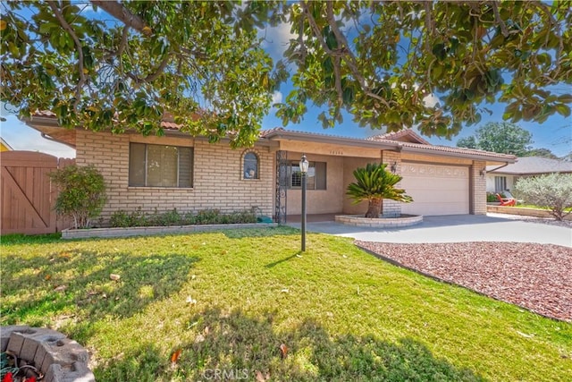 ranch-style home with an attached garage, brick siding, a front yard, and concrete driveway