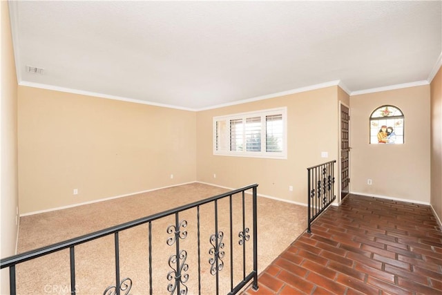 unfurnished room with brick floor, baseboards, and ornamental molding