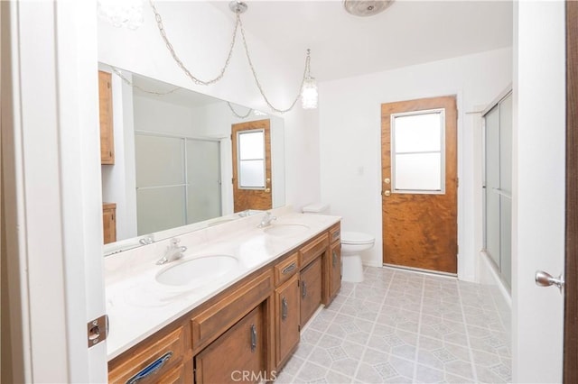 full bathroom featuring a sink, double vanity, and a healthy amount of sunlight