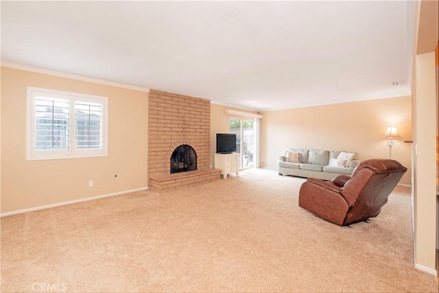 living area with crown molding, a brick fireplace, carpet flooring, and baseboards
