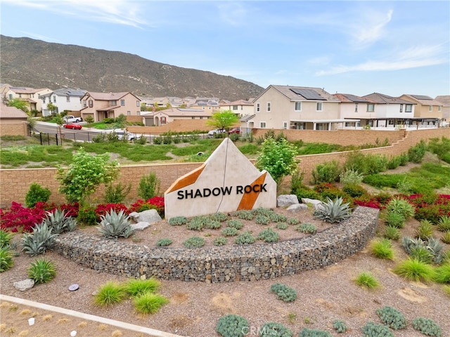 community sign with a residential view, fence, and a mountain view