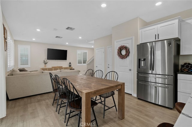 dining space with visible vents, light wood finished floors, and recessed lighting