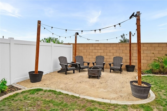 view of patio / terrace with a fenced backyard and an outdoor fire pit