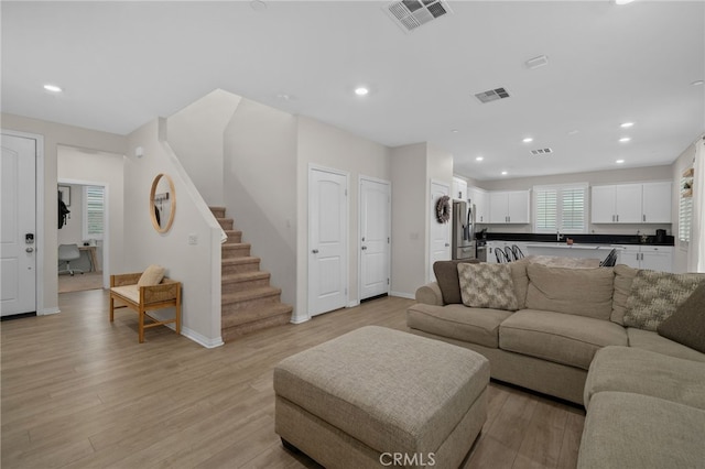 living room with recessed lighting and visible vents
