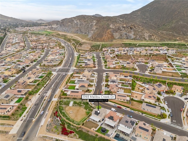 birds eye view of property with a residential view and a mountain view