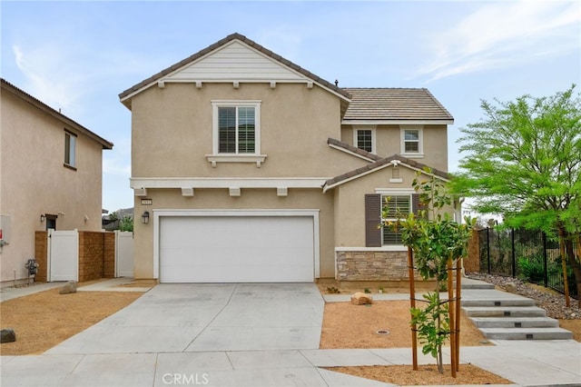 view of front of home with an attached garage, concrete driveway, stucco siding, and fence