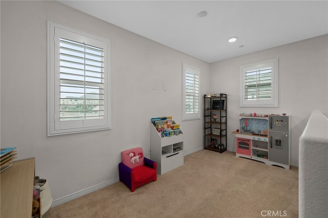 recreation room with carpet floors and baseboards