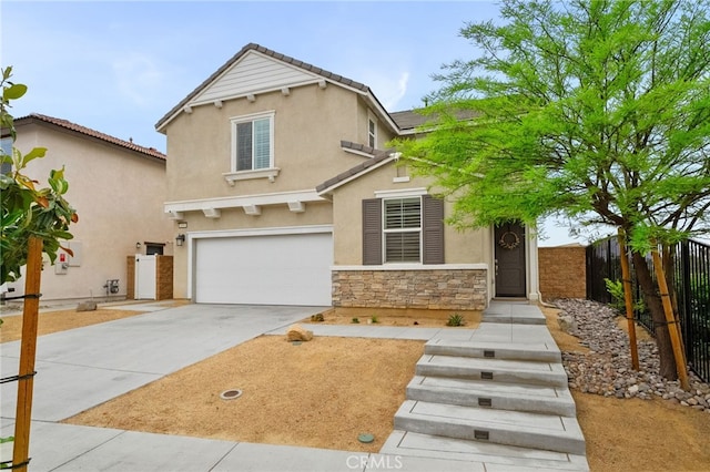 view of front of house with fence, stucco siding, an attached garage, driveway, and stone siding