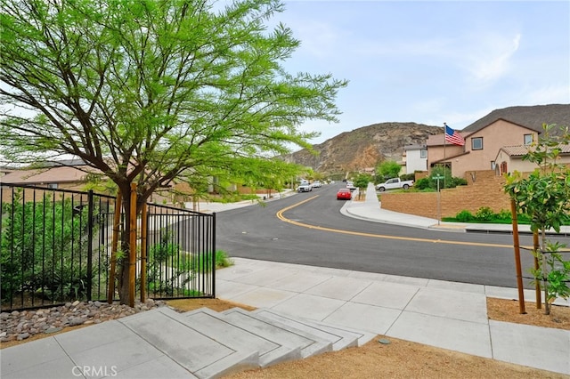 view of street featuring curbs, sidewalks, and a mountain view