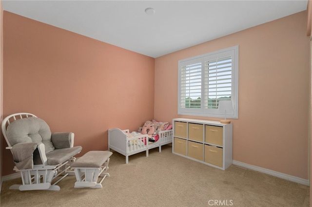 bedroom with baseboards and light colored carpet