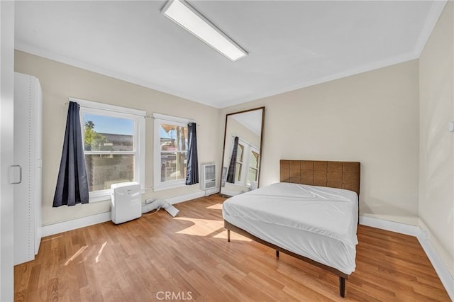 bedroom featuring light wood-type flooring and baseboards