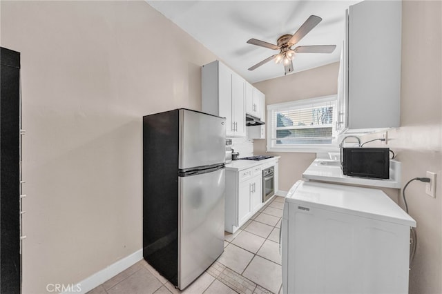 kitchen with light tile patterned floors, ceiling fan, light countertops, and black appliances