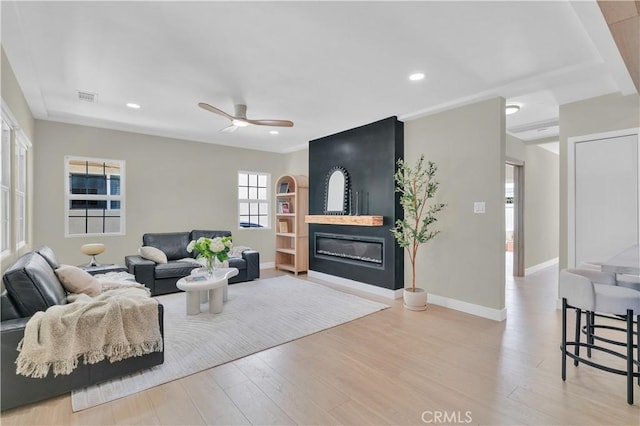 13301332 N Lincoln St, Burbank, CA 91506 - living room with visible vents, a glass covered fireplace, wood finished floors, and ceiling fan