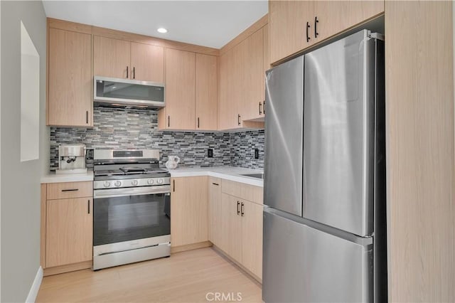 13301332 N Lincoln St, Burbank, CA 91506 - kitchen featuring decorative backsplash, light brown cabinetry, light wood-style floors, light countertops, and appliances with stainless steel finishes