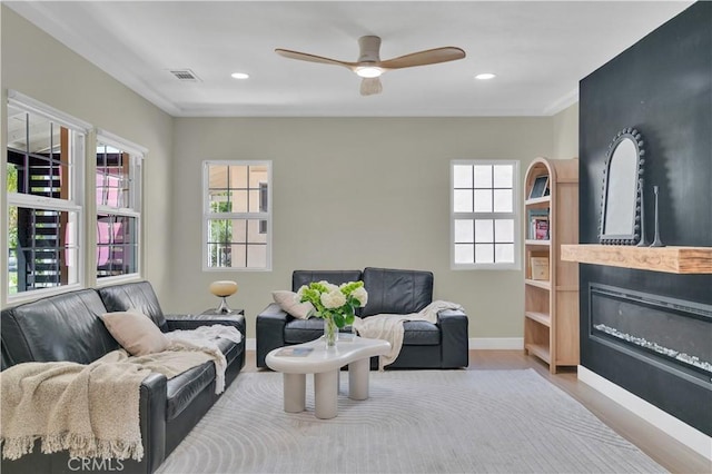 13301332 N Lincoln St, Burbank, CA 91506 - living area with visible vents, a glass covered fireplace, baseboards, a ceiling fan, and wood finished floors