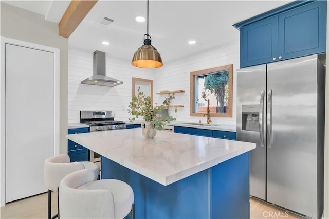 13301332 N Lincoln St, Burbank, CA 91506 - kitchen featuring wall chimney exhaust hood, a sink, blue cabinetry, and appliances with stainless steel finishes