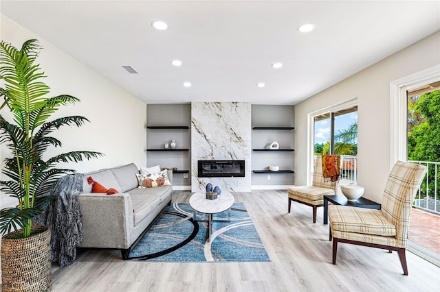 living area featuring wood finished floors, recessed lighting, and built in features