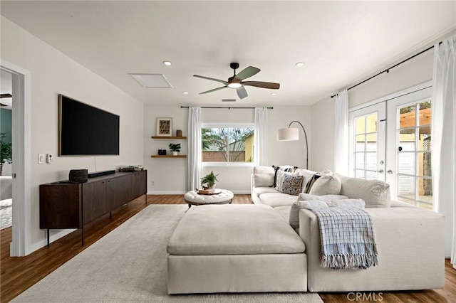 living room featuring a ceiling fan, french doors, wood finished floors, and recessed lighting