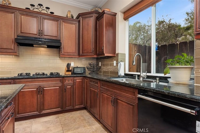 kitchen featuring a sink, dark stone counters, black appliances, under cabinet range hood, and ornamental molding