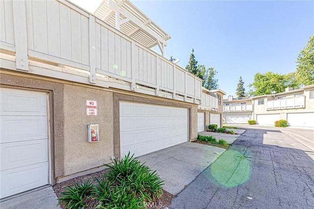 garage featuring concrete driveway
