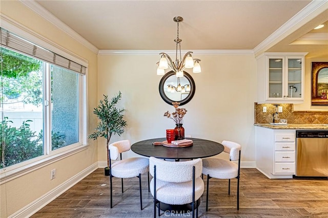 dining room with baseboards, an inviting chandelier, crown molding, and dark wood-type flooring