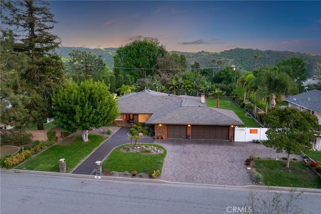 130 Mariposa Way, Brea, CA 92823 - view of front facade with a mountain view, a gate, driveway, fence, and an attached garage