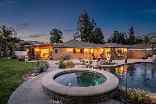 130 Mariposa Way, Brea, CA 92823 - back of property at dusk featuring a fenced in pool, fence, a patio area, an in ground hot tub, and a lawn