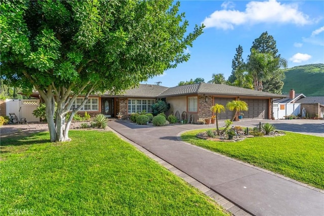 130 Mariposa Way, Brea, CA 92823 - view of front of property featuring a garage, a front lawn, aphalt driveway, and fence