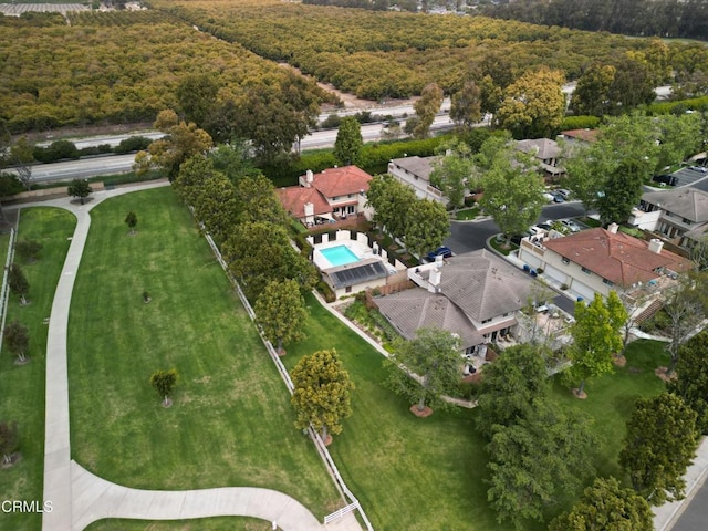 drone / aerial view featuring a wooded view