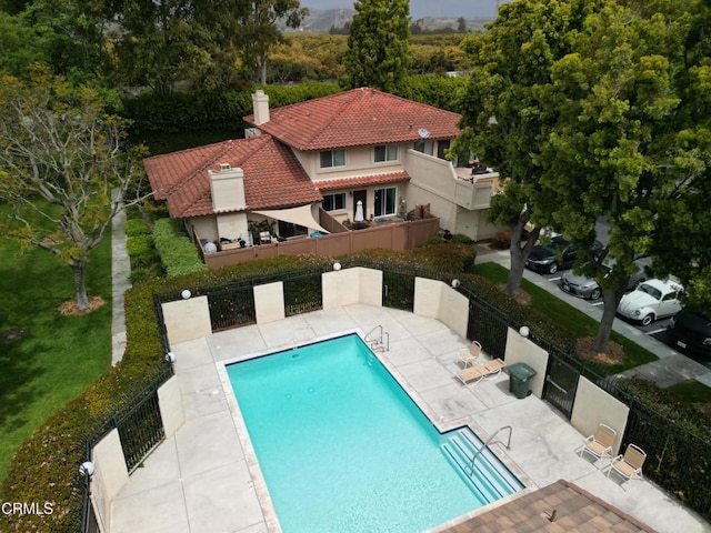 pool with fence and a patio