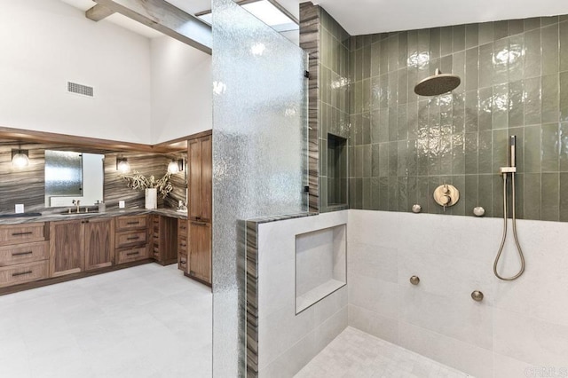 full bath with walk in shower, vanity, tile patterned floors, and visible vents