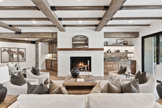 living room featuring wood finished floors, recessed lighting, and a lit fireplace
