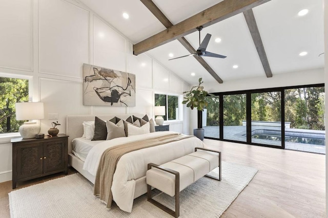 bedroom featuring beamed ceiling, multiple windows, and access to outside