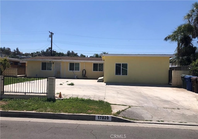 single story home with fence and stucco siding