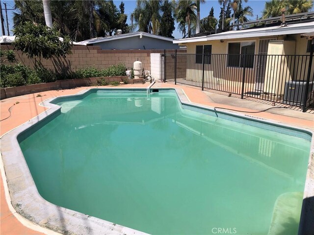 view of swimming pool featuring a fenced in pool, a patio area, and fence