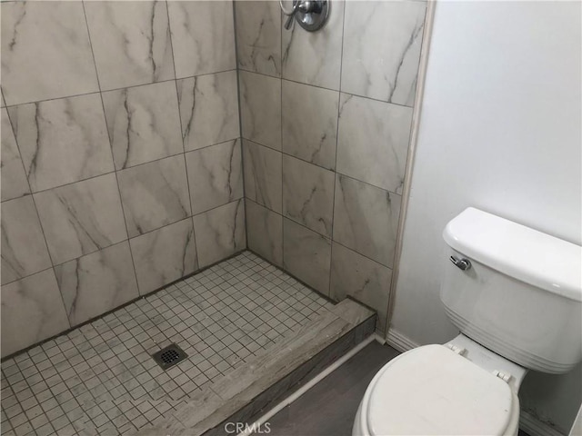 bathroom with toilet and a shower stall