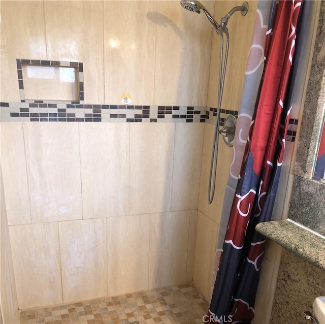 full bath featuring a tile shower