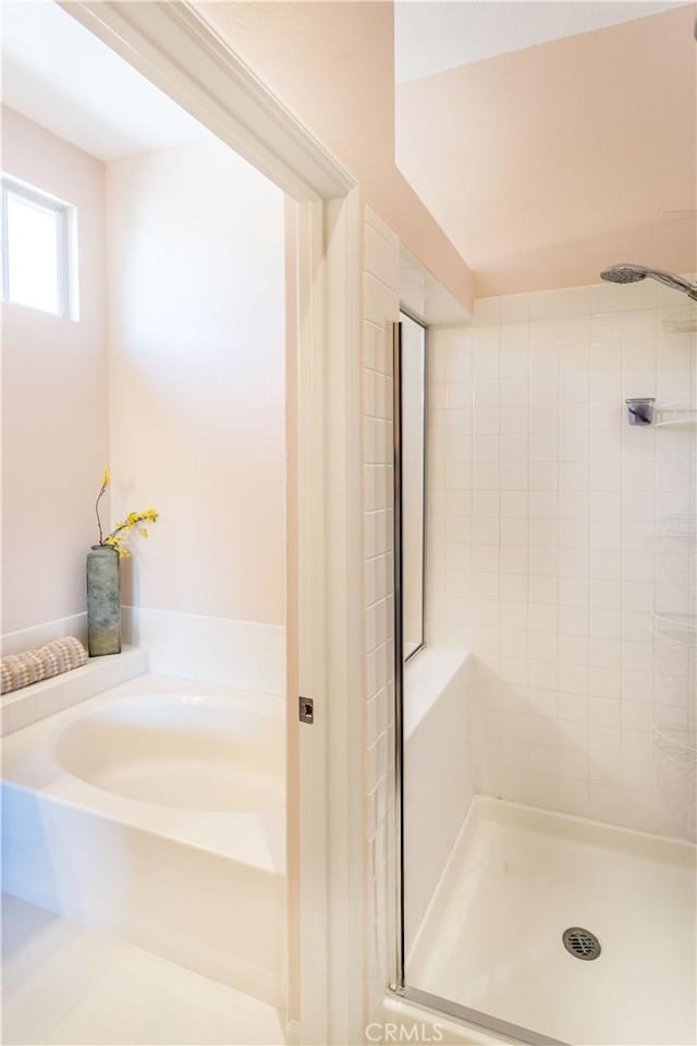 full bathroom with a bath and a stall shower