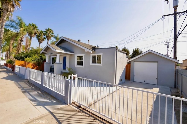 3222 E 10th St, Long Beach, CA 90804 - bungalow with stucco siding, driveway, an outdoor structure, and a garage