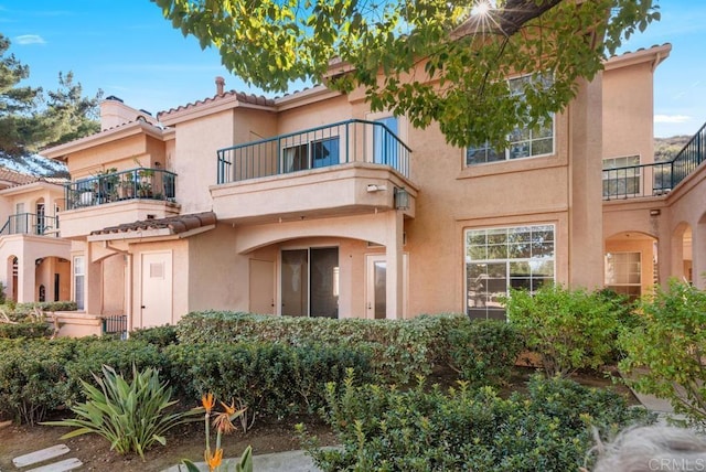18614 Caminito Cantilena Unit 324, San Diego, CA 92128 - back of house featuring a balcony, stucco siding, and a tiled roof