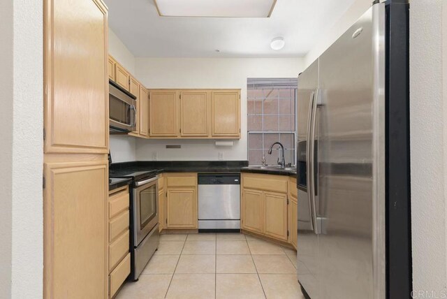 18614 Caminito Cantilena Unit 324, San Diego, CA 92128 - kitchen with appliances with stainless steel finishes, a sink, dark countertops, and light brown cabinets