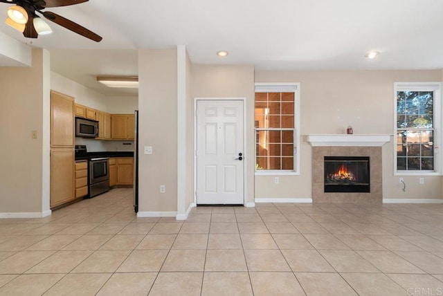 18614 Caminito Cantilena Unit 324, San Diego, CA 92128 - unfurnished living room featuring a ceiling fan, light tile patterned flooring, baseboards, a tiled fireplace, and recessed lighting