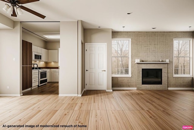 18614 Caminito Cantilena Unit 324, San Diego, CA 92128 - unfurnished living room featuring baseboards, plenty of natural light, ceiling fan, and light wood-style flooring