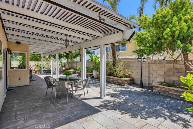 view of patio with a pergola, a fenced backyard, and outdoor dining space