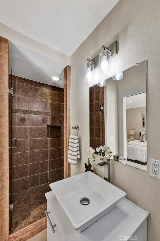 full bath featuring a shower stall and a sink