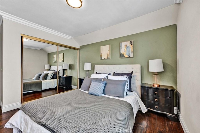 bedroom featuring baseboards, wood finished floors, and ornamental molding