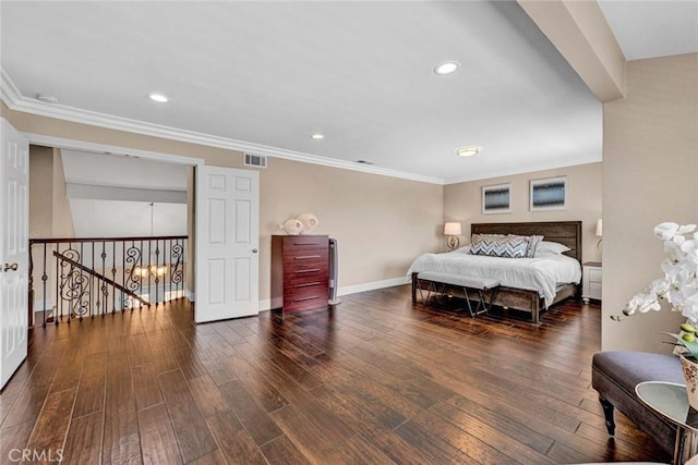 bedroom with ornamental molding, wood finished floors, baseboards, and recessed lighting