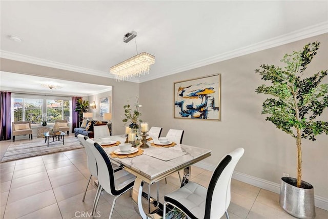 dining area with crown molding, a chandelier, baseboards, and light tile patterned floors