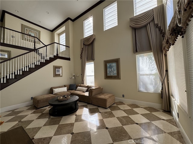 tiled living room with baseboards, a towering ceiling, stairway, and crown molding